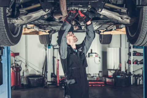 Man Repairing Suspension of car