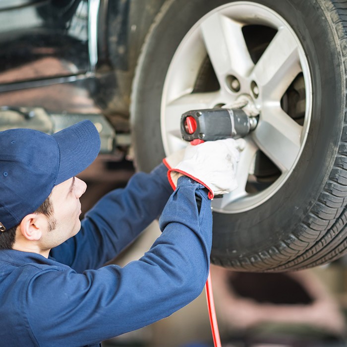 Man working on tire installation in Gastonia, NC