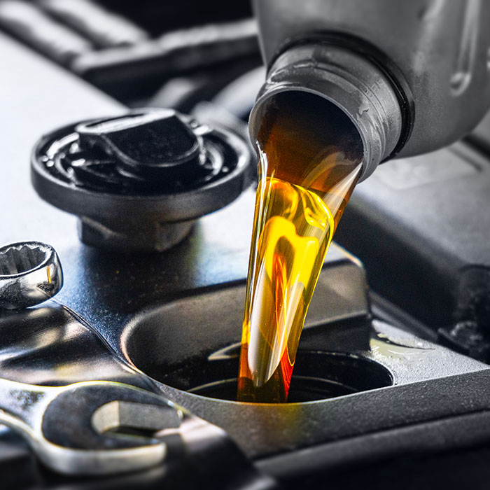 Pouring motor oil into an engine