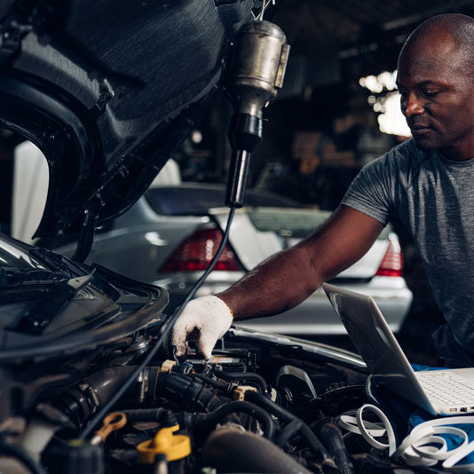 mechanic wearing gloves checking the car