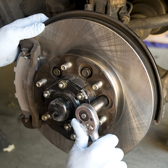 a mechanic fixing car's brake