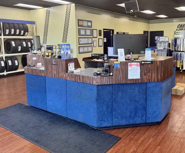 Car service reception area with a wooden counter and blue panels